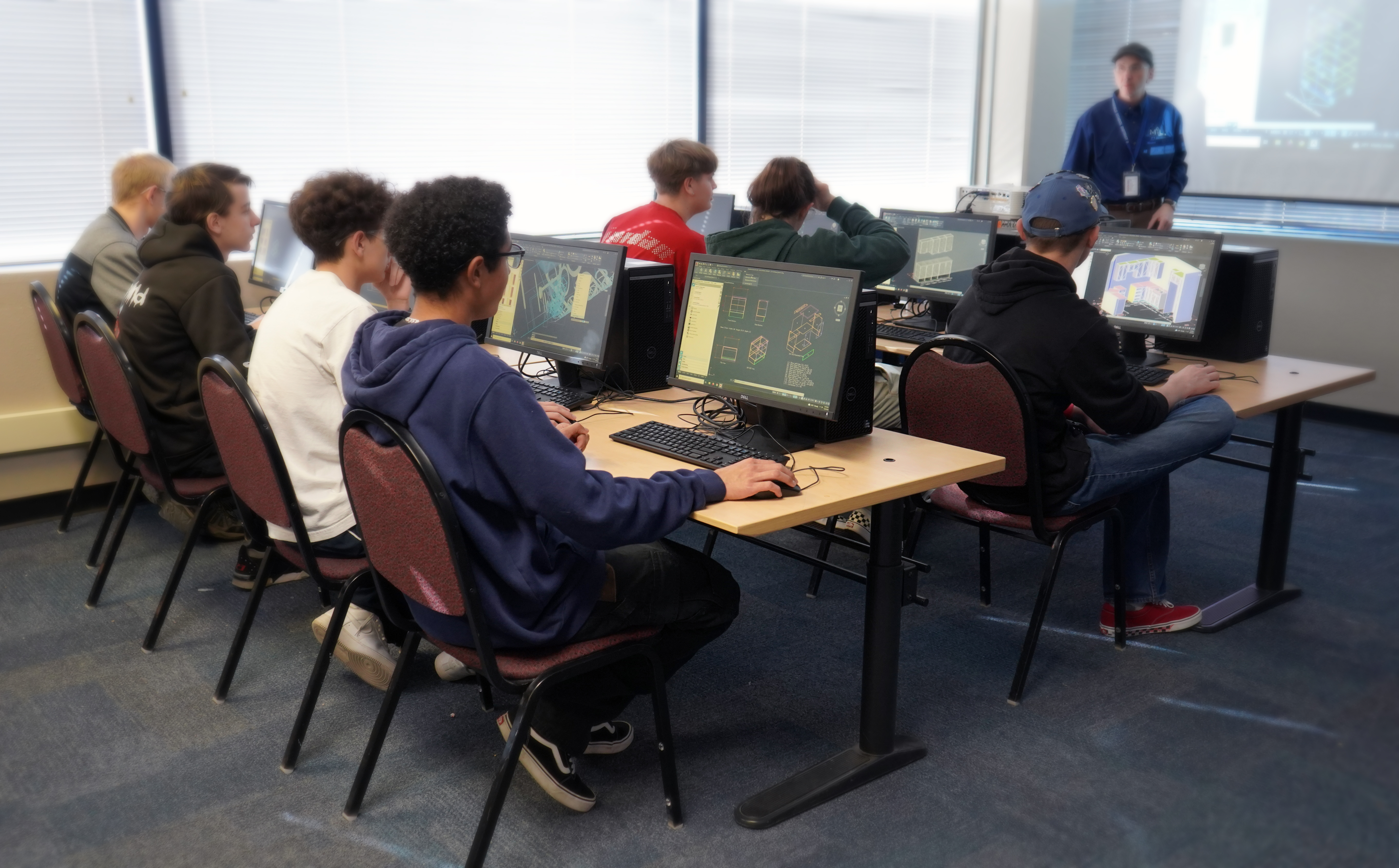 Students in a classroom environment learning how to use MIcrovellum's AutoCAD-based cabinet design-to-manufacturing software, Toolbox.